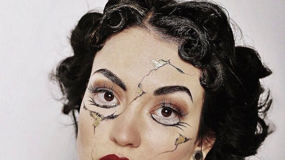 A BNU hair and make-up student with crack like paintings on her face