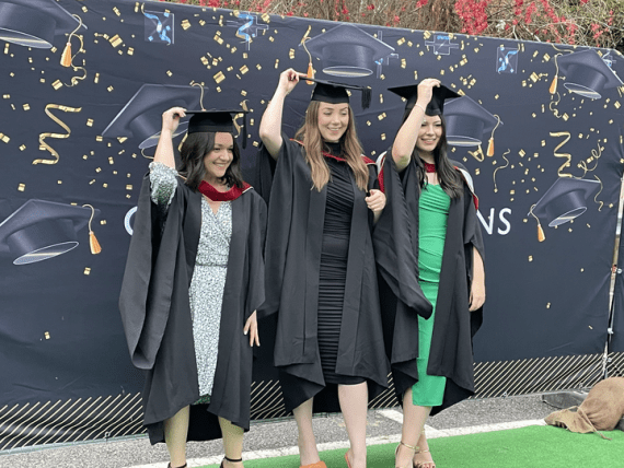Graduation Class of 2021 students holding mortar board hats