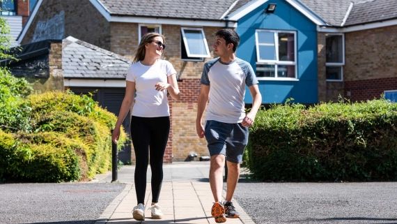 Two students walking together outside Brook Street accommodation