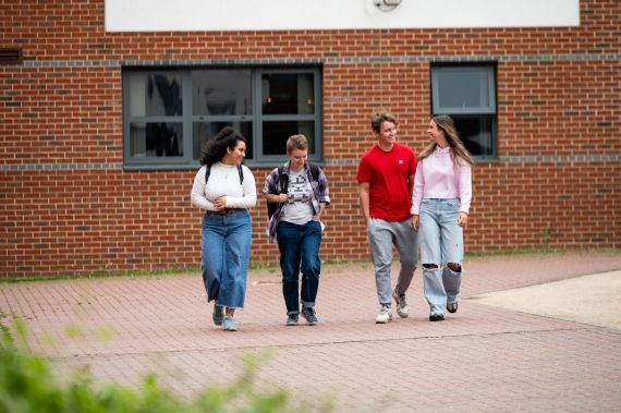 Four students outside Hughenden accommodation in High Wycombe campus