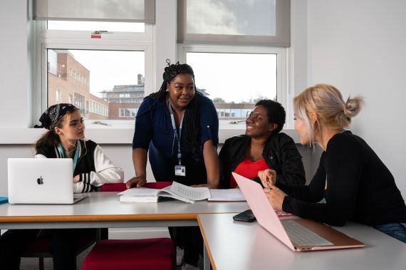 Lecturer talking to students in classroom
