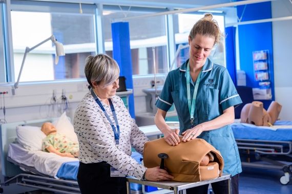 Midwifery students with dummy