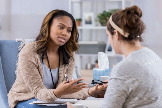 Two women talking at a psychologist office