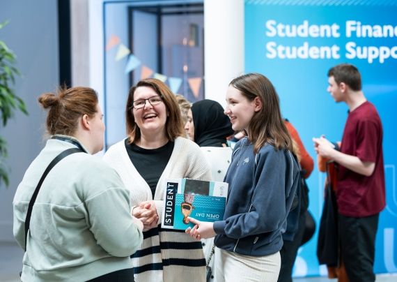Prospective students talking to a member of BNU staff at an Open Day