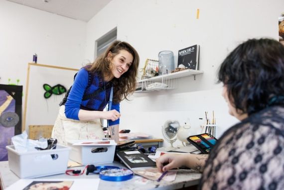 Fine art lecturer helping a student