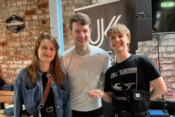 Two students stood either side of a BNU lecturer at the UK Music Awards.