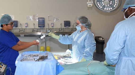 Simulation operating room with Bucks students in gowns using equipment