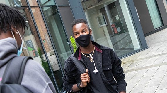 Two students wearing face coverings