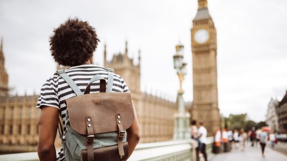 Back of male student looking at the Big Ben in London