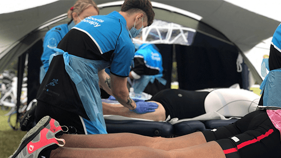 Student in BNU uniform carrying out therapy on runner