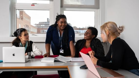 Lecturer talking to students in classroom