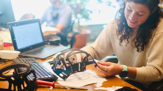 An animatronics Design BNU student with a laptop and a mask