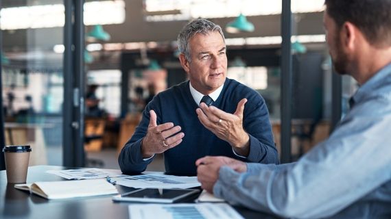 two men sat in conversation in an office
