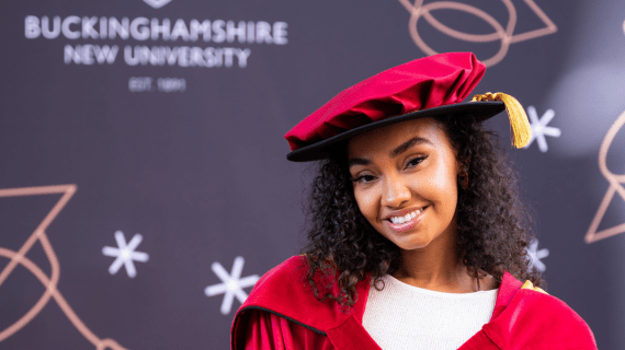 Leigh-Anne smiling whilst wearing Graduation attire.