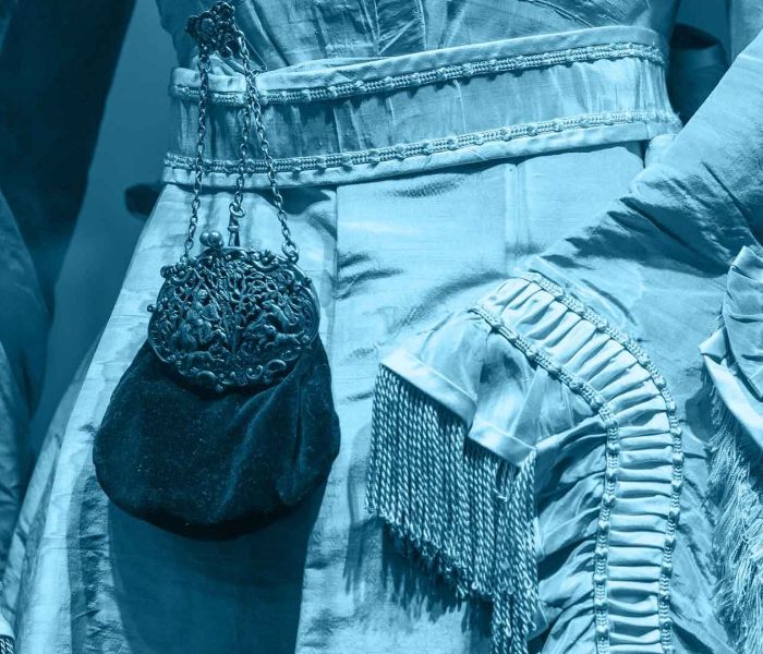 A close up of the midline of a blue victorian style dress 