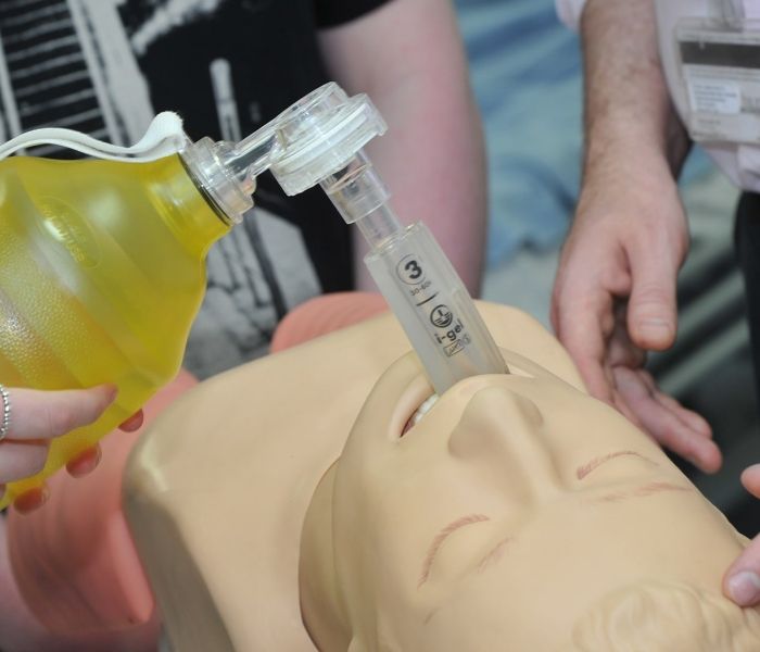 Bucks lecturer demonstrating use of a breathing aid device on a mannequin