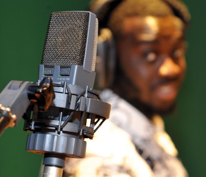 Bucks music student standing next to a vocal recording microphone