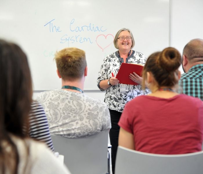 Nursing lecturer teaching a group of students