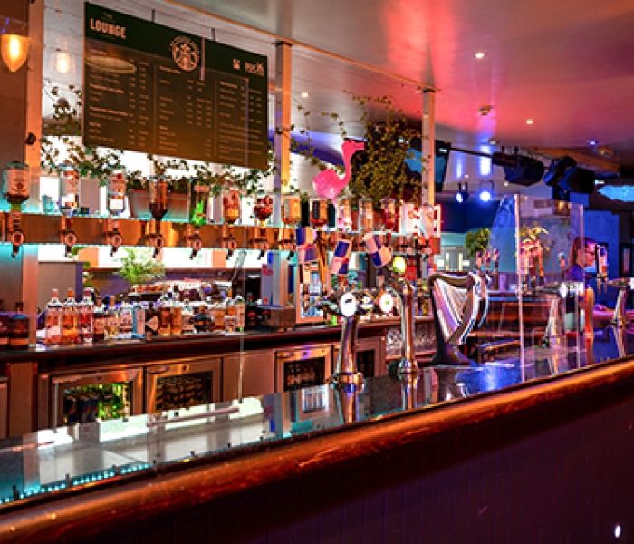 Students' Union bar with a student talking to the bar staff