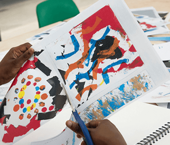 A female student cutting through paper