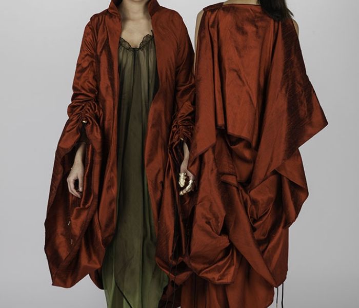 Fashion Design Students stood in red outfits