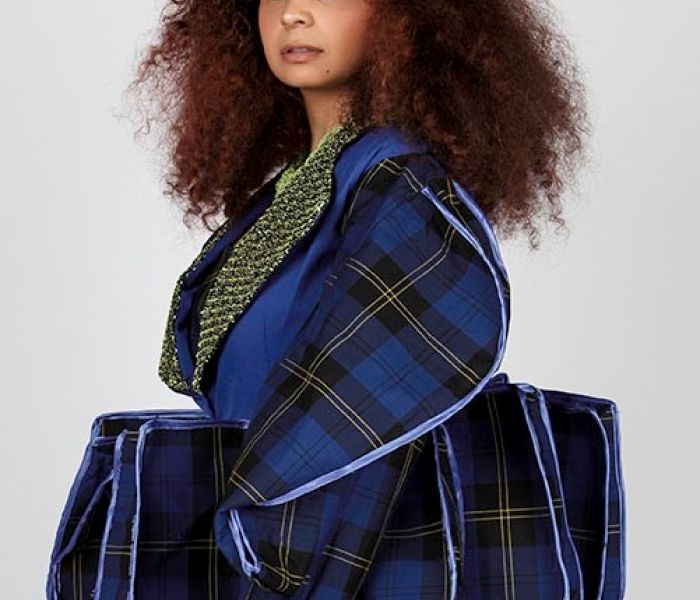 Fashion Design Student work stood in blue outfit