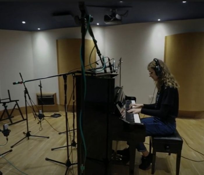 music student playing piano in studio