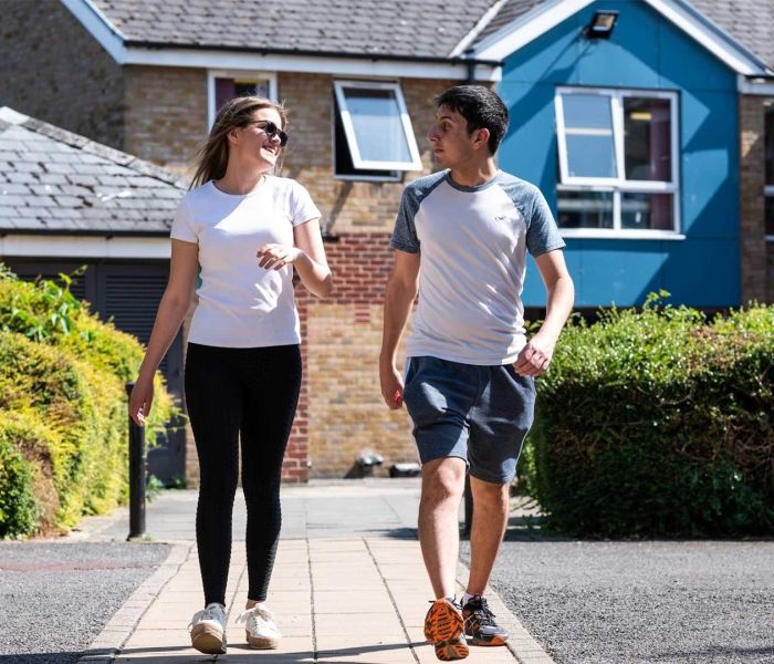 Two students walking together outside Brook Street accommodation