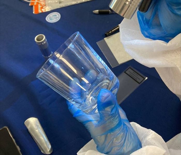 student holding criminology items during forensic studies