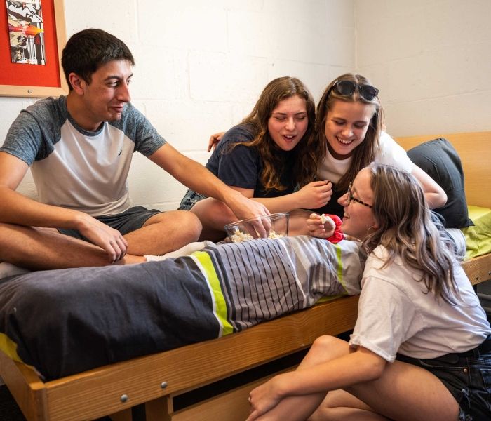 4 students eating popcorn and socialising in a Brook Street bedroom