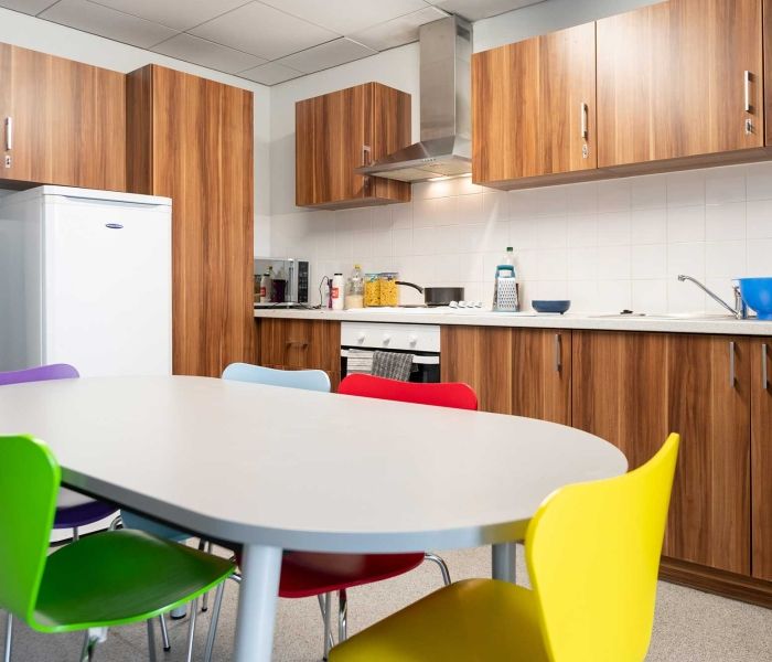 Windsor House kitchen, including table, chairs, fridge, cooker, microwave