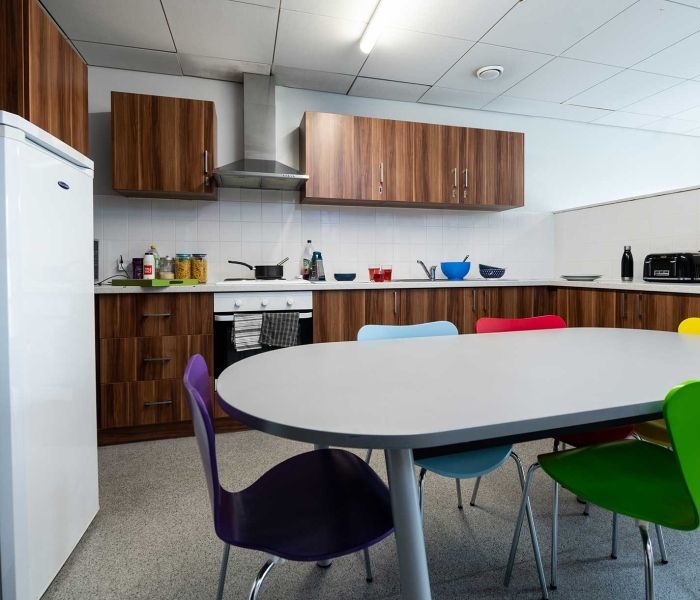 Windsor House kitchen, including table, chairs, fridge, cooker, sink, toaster, kettle