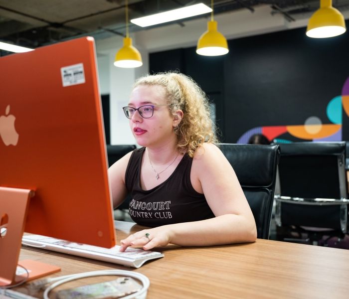 Creative Advertising student at laptop