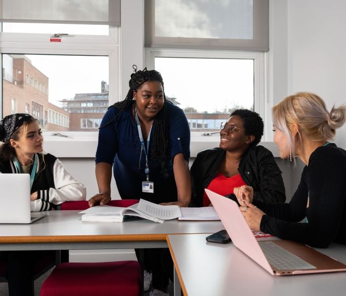 Lecturer talking to students in classroom