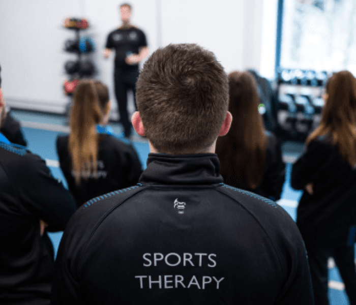 A Sports Therapy class looking towards the teacher.