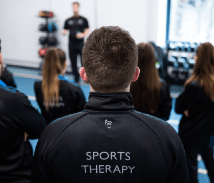 A Sports Therapy class looking towards the teacher.