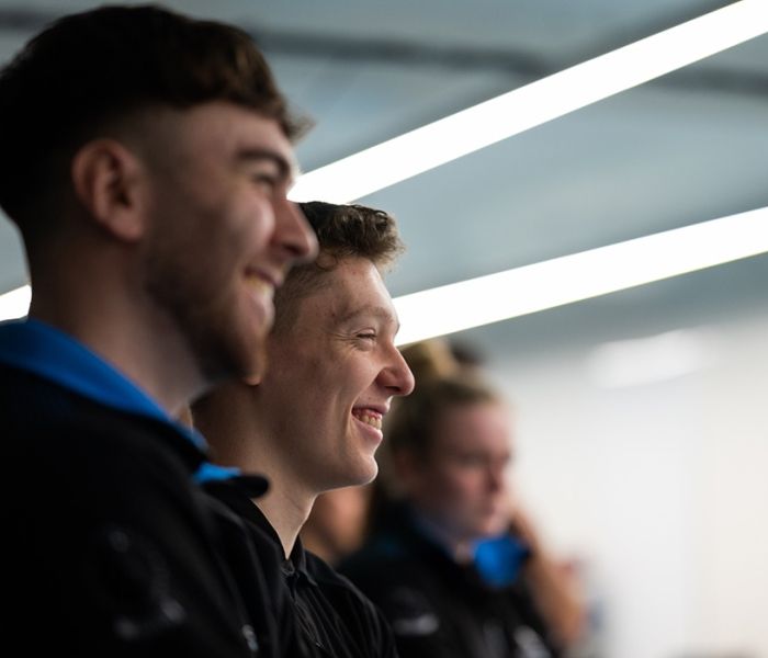 Sports Therapy students watching a demonstration and smiling