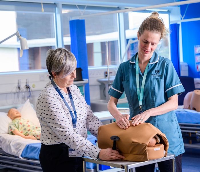 Midwifery students with dummy