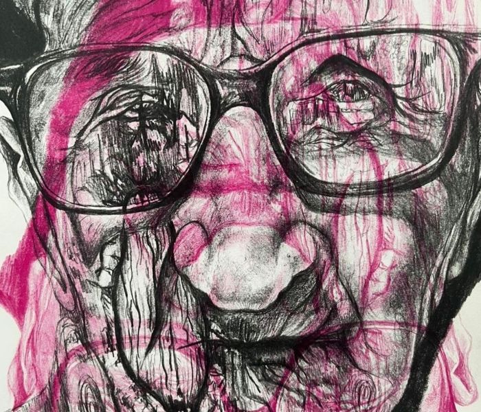 A drawing of a man's face with pink splashes over his face.