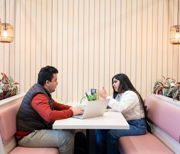 Two students in a booth at the Garden Cafe