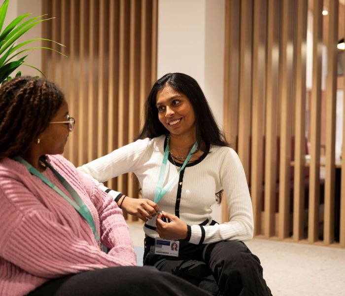 Two students chatting in the Atrium