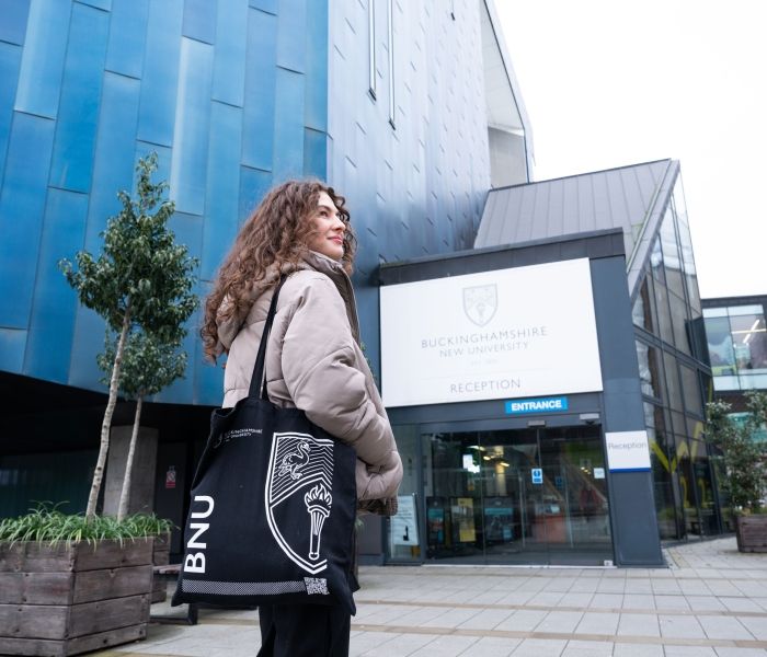 Female student outside gateway building on High Wycombe campus