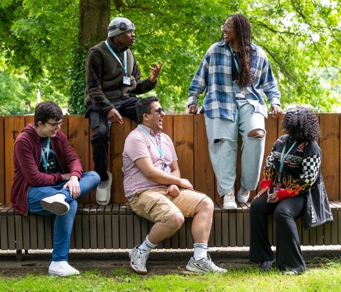 Five students sitting on a bench at High Wycombe campus