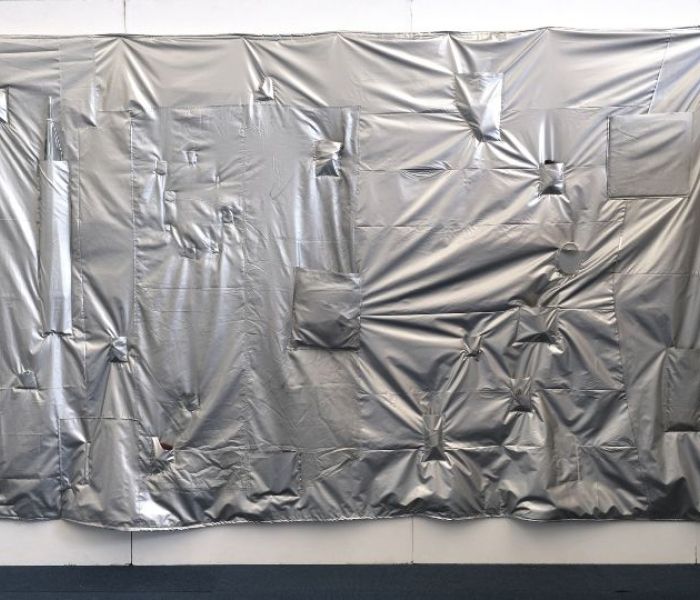 A silver sheet moulded onto a wall.