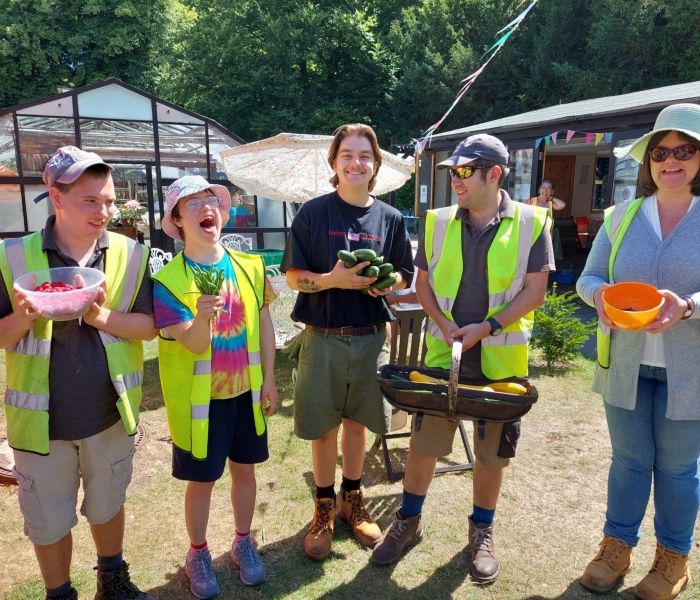 Five people hold the produce grown at Missenden Walled Garden