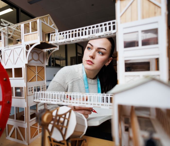 Interior and Spatial student examining an architectural model