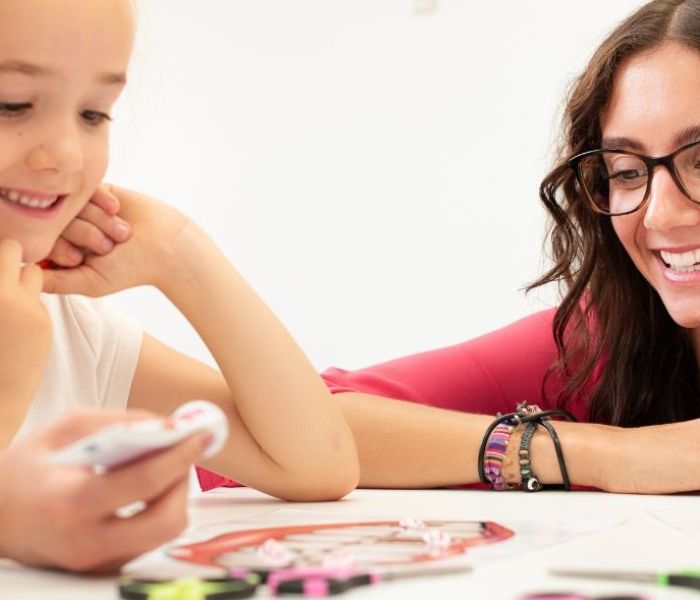 Occupational Therapist supporting a young child through play therapy.