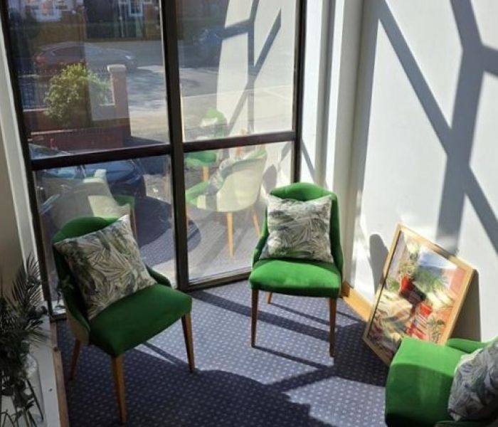 Picture of communal lounge at Alex House with chairs and cushions