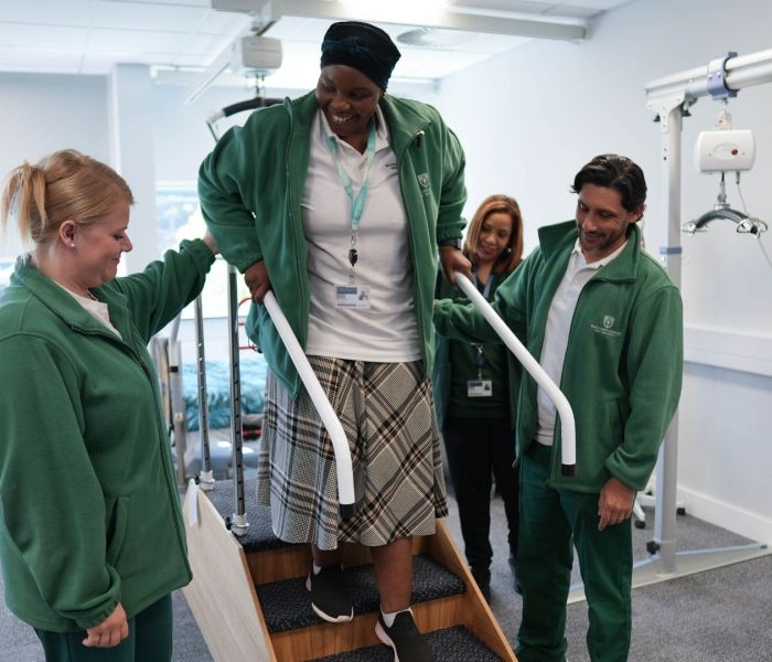An Occupational Therapy student walking down some stairs in a classroom setting.