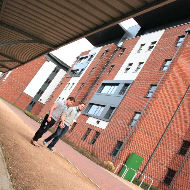 Two Bucks students walking outside Hughenden Park Student Village Accommodation